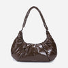 A glossy texture Croissant-shaped shoulder bag in glossy brown color by Dude & Bestie