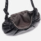 A black shiny Croissant-shaped shoulder bag with a single strap in polish black color