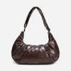 A dark brown shiny Croissant-shaped shoulder bag in polish brown color by Dude & Bestie