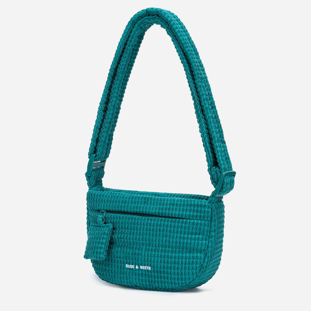 A teal woven corduroy shoulder bag by Dude & Bestie Winter 2026 Series