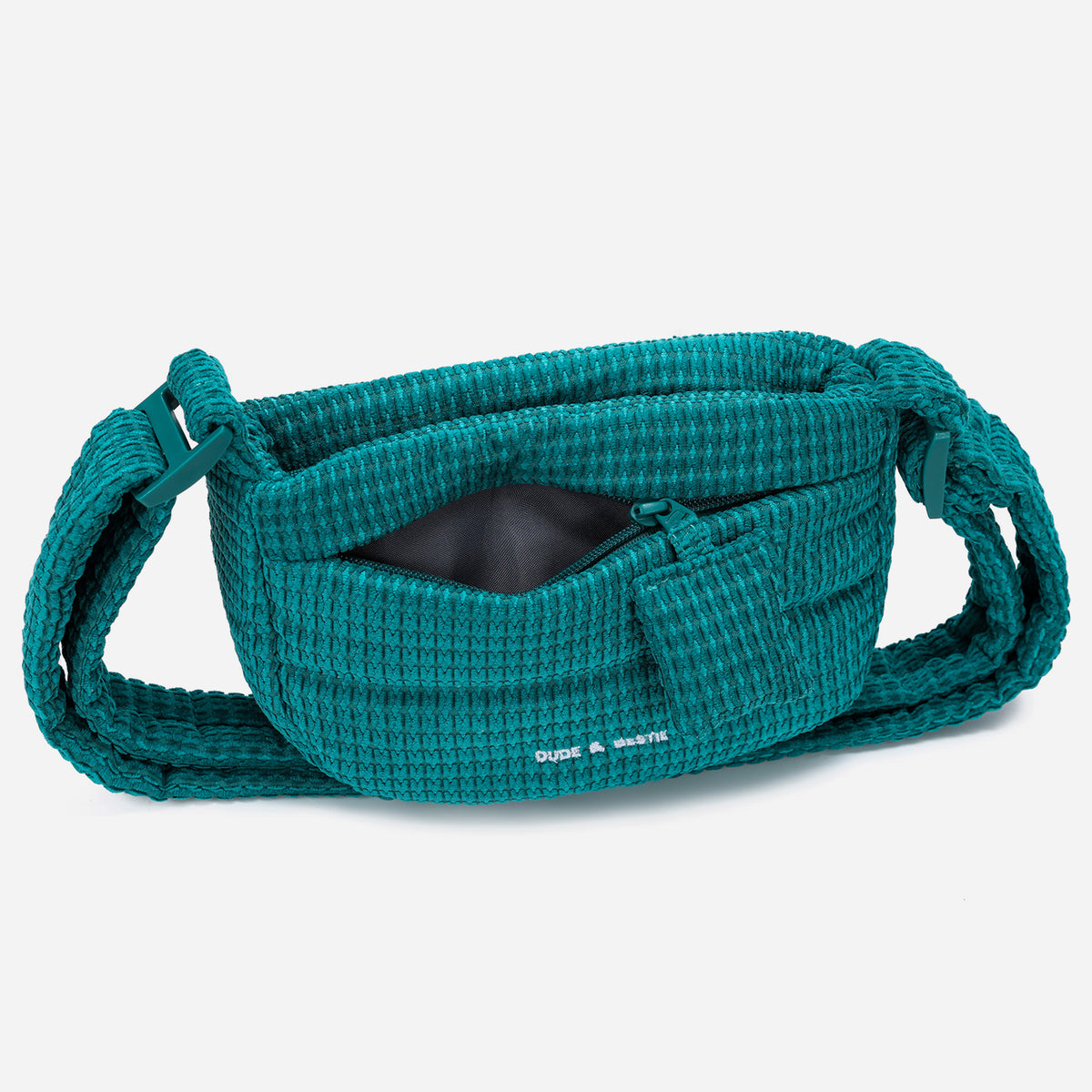 A teal woven corduroy shoulder bag by Dude & Bestie Winter 2026 Series