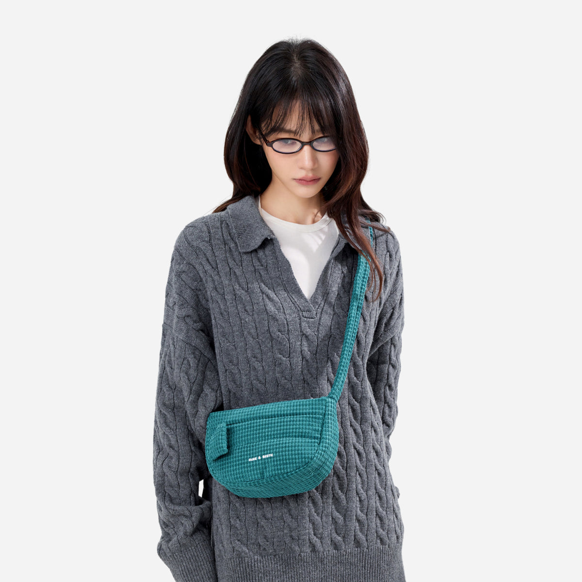A teal woven corduroy shoulder bag by Dude & Bestie Winter 2026 Series