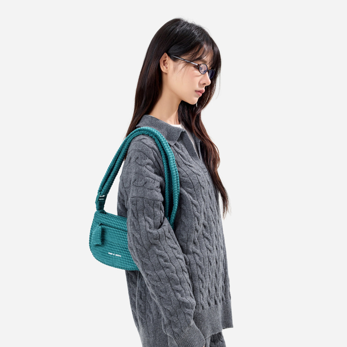 A teal woven corduroy shoulder bag by Dude & Bestie Winter 2026 Series